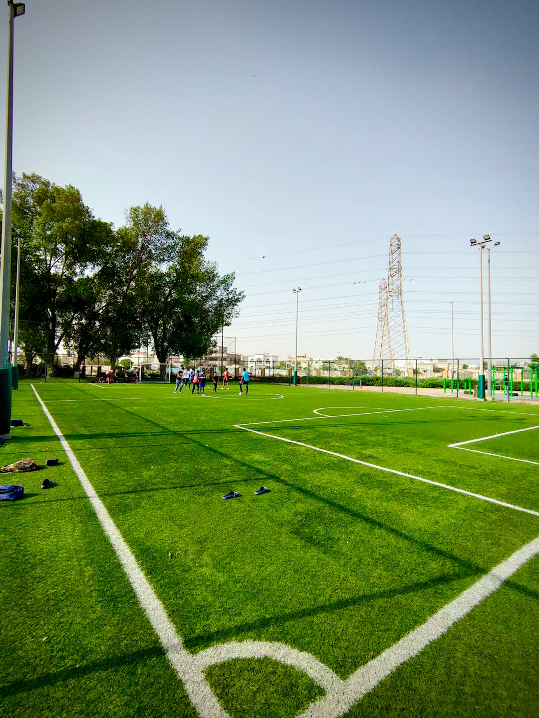 Group of young people playing soccer on a turf field.